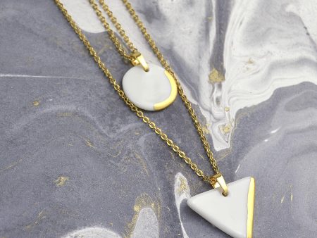 Geometric Layered Necklace, Circle and Triangle Pendants. Minimalist ceramic jewelry decorated with real gold. Design by Gruni.